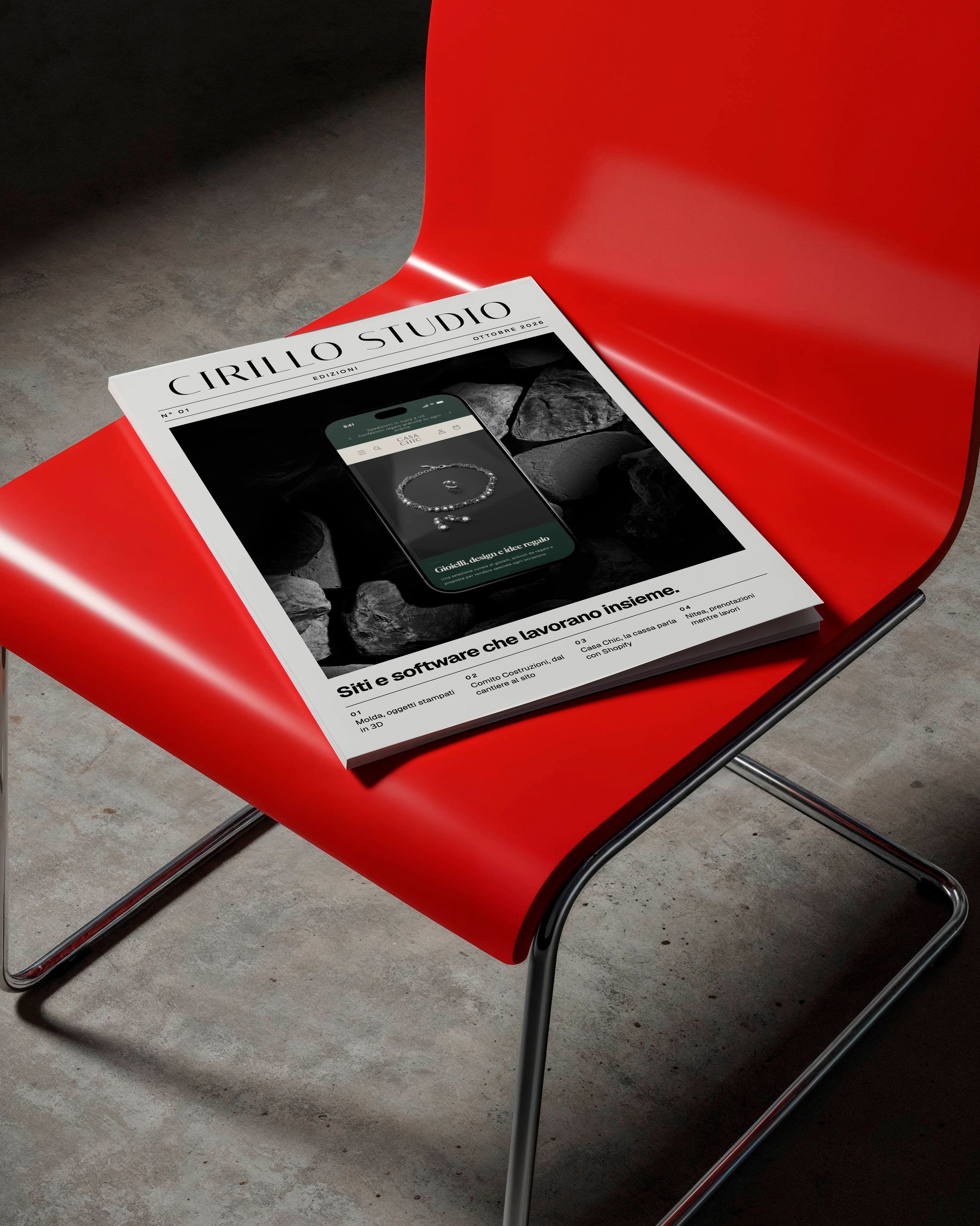 Copertina della rivista di Cirillo Studio appoggiata su una sedia rossa.